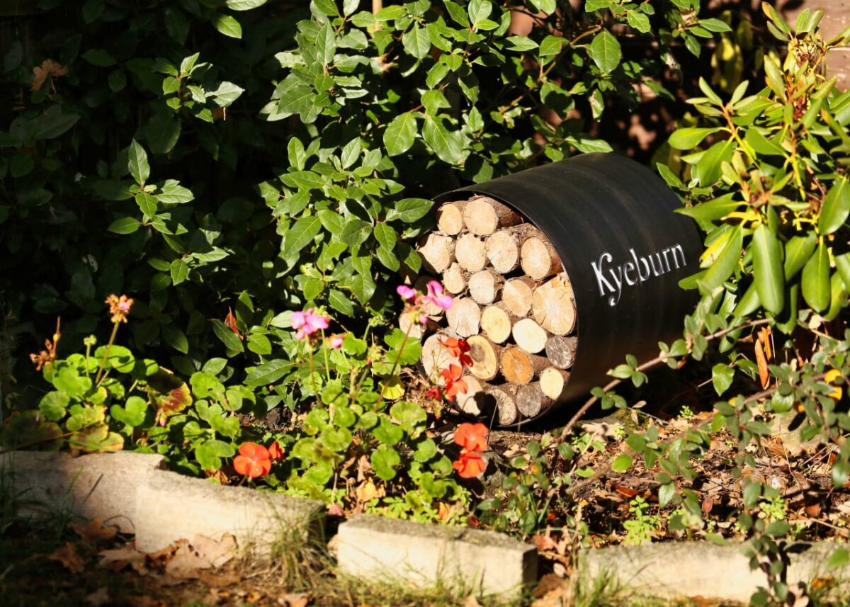 Kyeburn Log Store Circular In flower bed